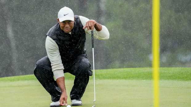 Tiger Woods lines up his putt on the 18th green during the second round of The Masters in April.